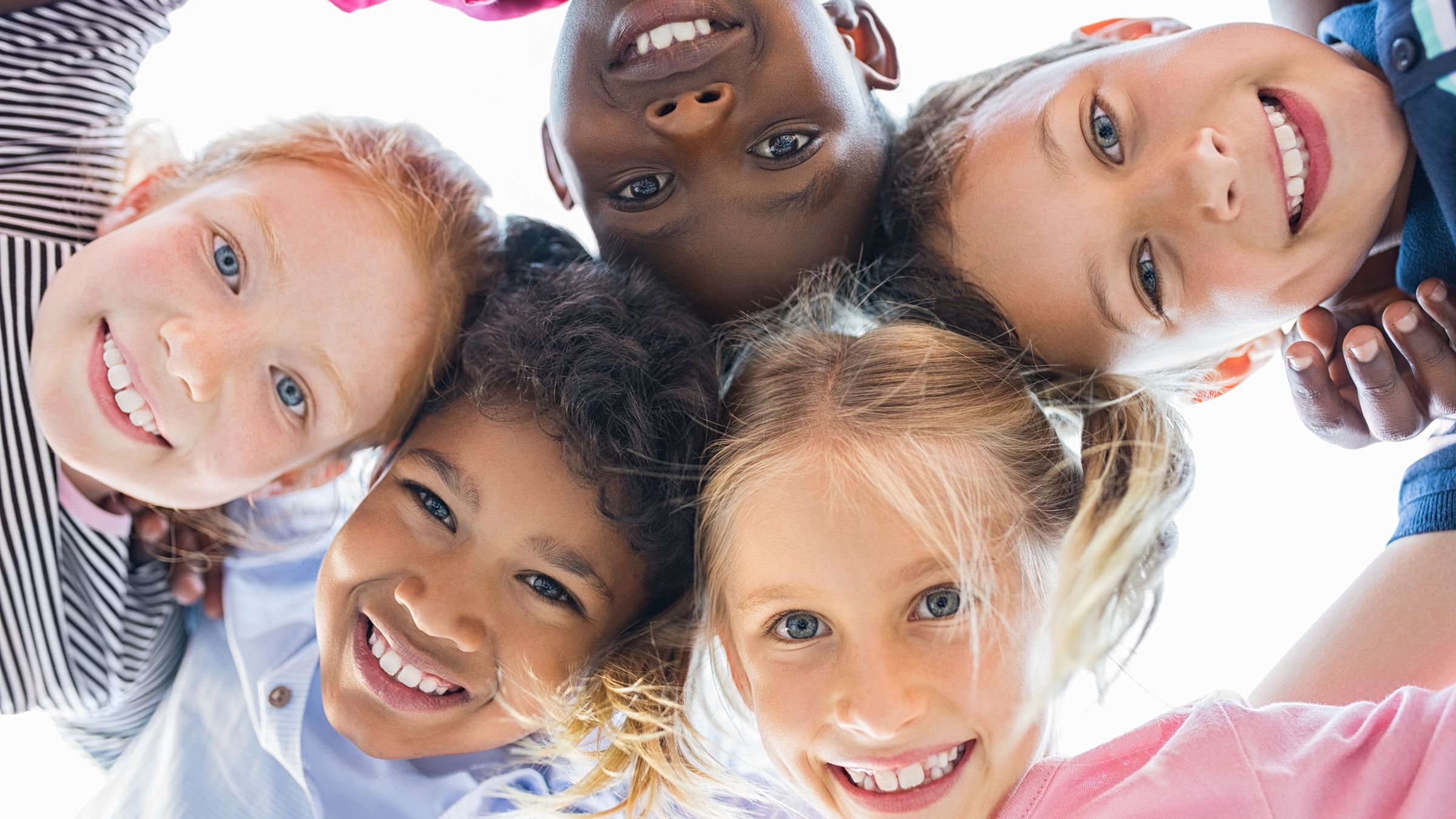 Kids smiling in a circle
